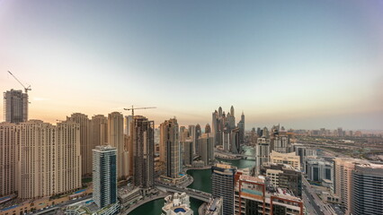 View of various skyscrapers in tallest recidential block in Dubai Marina aerial day to night timelapse