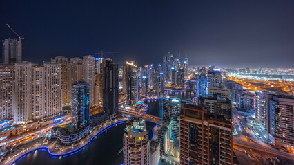 View of various skyscrapers in tallest recidential block in Dubai Marina aerial night timelapse