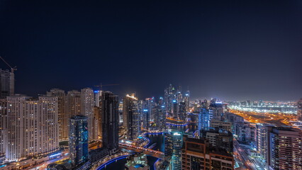 Fototapeta na wymiar Panorama of various skyscrapers in tallest recidential block in Dubai Marina aerial all night timelapse