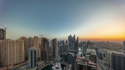 View of various skyscrapers in tallest recidential block in Dubai Marina aerial all day timelapse