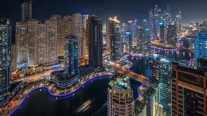 Panorama showing various skyscrapers in tallest recidential block in Dubai Marina aerial night timelapse