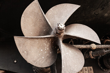 The ship's bronze propeller on the propeller shaft at the stern of the ship.