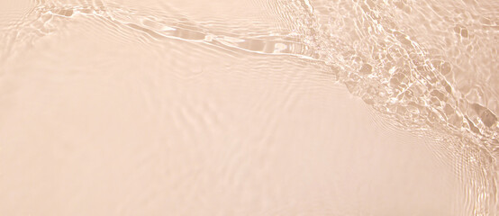 Abstract summer banner background Transparent beige clear water surface texture with ripples and...