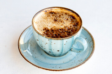 Coffee with milk on a white background. Cup of coffee with milk on the table. close up