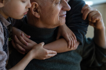 Fototapeta premium Family bonding. grandfather and child holding hands together, closeup view. Panorama