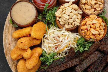 Beer snacks, peanuts, nuggets, squids, sauces, croutons