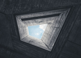 Looking up at the sky through pentagonal shaped light well. Concrete brutalist architecture
