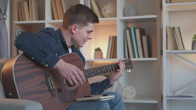 Guitar learning. Musician burnout. Creativity loss. Annoyed frustrated man guitarist struggling to play song chords, failing music practicing at home.