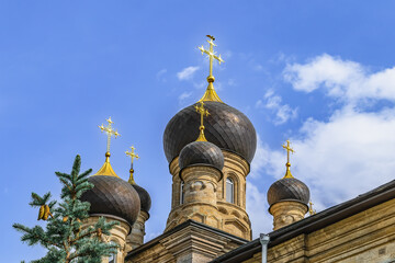 Fototapeta na wymiar Mykolaiv, Ukraine - July 26, 2020: Towers with domes and golden crosses of Cathedral of the Kasperovsky Icon of the Mother of God in Mykolaiv. Beautiful elements of the exterior of an Orthodox church