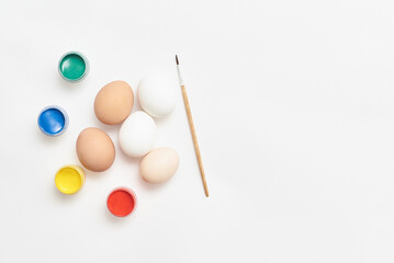 Eggs and paints for Easter on a white background