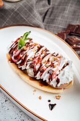 Banana split dessert with nuts and syrup