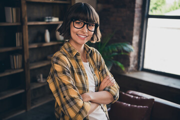 Portrait of charming good mood pretty businesswoman with folded arms wearing eyeglasses relaxing at...