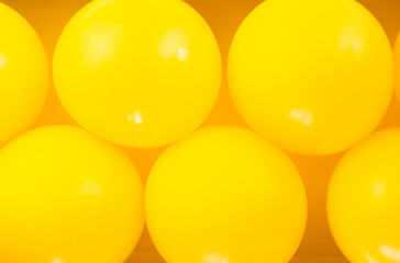 Group of yellow balloons create a background.