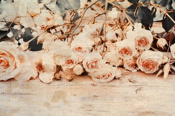 Bouquet of vintage rose on old wooden table - grunge texture
