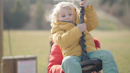 Child on playground zip line have fun