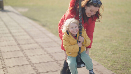 Fototapeta premium Grandmother and grandchild laughing on a zip line enjoy time together