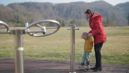 Grandmother and grandchild doing stupid things on outdoor gym equipment