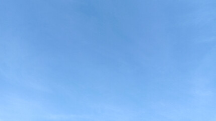 Blue sky with a thin white cloud