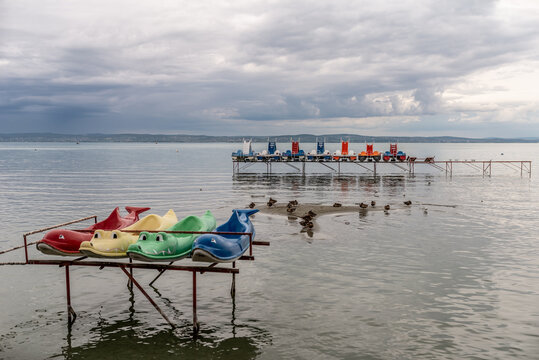 Colorful Pedalos at the Balaton Lake, Siofok, Hungary. Dramatic cloudy sky as background. End of touris season.