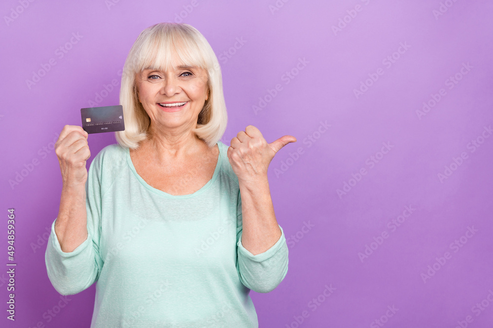 Sticker Photo of grandma hold debit card direct finger empty space loan option wear teal shirt isolated violet color background