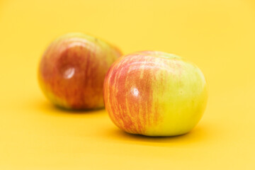 Red apple isolated on yellow background. Clipping path. Fresh organic apple collection.