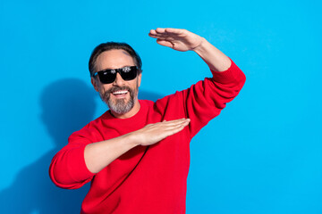 Naklejka premium Portrait of attractive cheerful man dancing fooling having fun rest free time isolated over bright blue color background