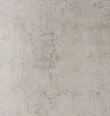 A worn gray concrete wall with scratches and stains. Gray background with texture. The old wall.
