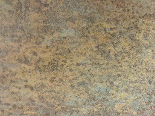 An old brown wall with dark spots. Brown, vintage background with a mottled texture.
