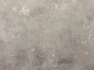 The smooth concrete wall is gray with spots. Gray background with texture. Worn surface.
