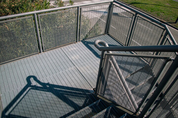 architecture: steel staircase of a pedestrian walkway, stainless steel structure, fireproof.