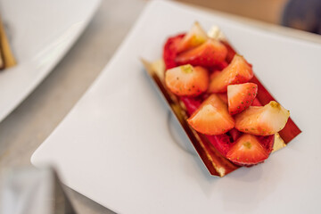 Sliced strawberries isolated on white background, selective focus, close-up shot in elegant luxury restaurant. Strawberry cake 