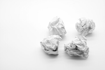 crumpled paper on white table brainstorming in the office concept                 