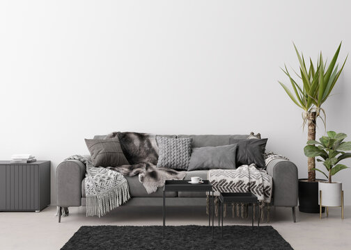 Empty white wall in modern living room. Mock up interior in contemporary, scandinavian style. Free, copy space for picture, poster, text, or another design. Sofa, table, plants. 3D rendering.