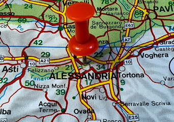 Closeup shot of a red pushpin on the map of Alessandria city in Italy