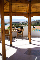 Happy young woman walking on hotel territory. Summer vacation in Egypt. Stylish fashionable look