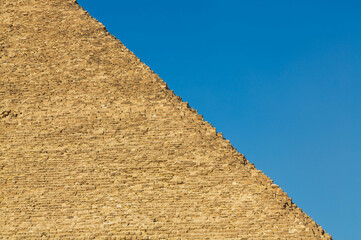 Yellow bricks and blue sky, texture and colour. The great Pyramid complex of Giza. Cairo, Egypt