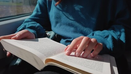 reading book on train - Powered by Adobe