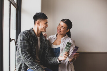 Mid adult couple choosing wall paint colours
