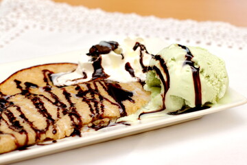 Home made pancake, crepe with chocolate and ice cream