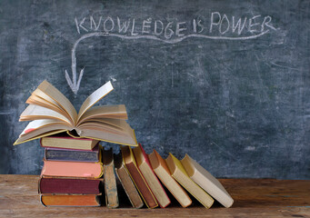 books and blackboard with slogan knowledge  is power,learning,education,personal development and...