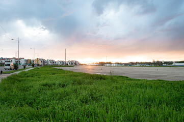 Fototapeta na wymiar sunset in city, grass in the setting sun, sunsets in sochi, sirius, nature and sunset