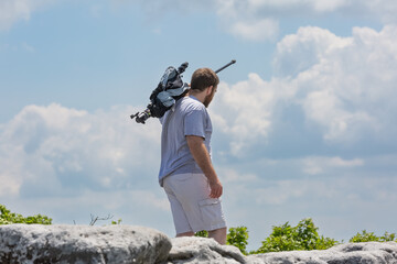 Caucasian man carrying a photography tripod at the Bear Rocks in Dolly Sods, WV