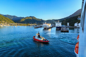 View of the town of Picton, New Zealand, from a cruise liner in Queen Charlotte Sound. A tugboat is...