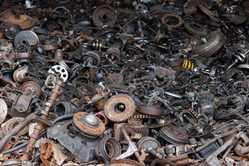 a pile of waste automotive parts in recycle factory. scrap metal - predominantly ferrous metals....