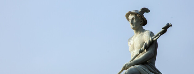 Ancient statue of antique god of commerce, business, merchants, travelers and  cunning Hermes...