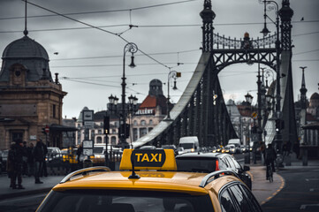 Yellow taxi cab car parked near the Liberty bridge in Budapest, Hungary
