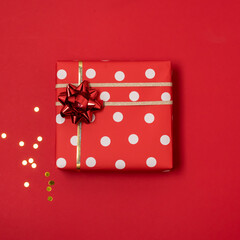 Composition With Gifts Boxes Wrapped in Red Wrapping Paper with a Gold Ribbon Red Background Top View