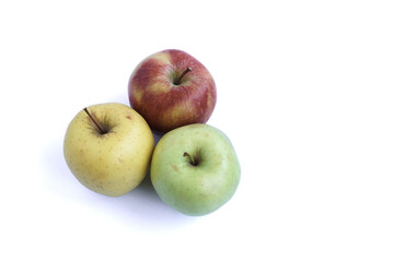Top view of red, yellow and green apples on a white background.