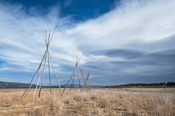 A row of tipi (teepee) frames on the Stoney Indian Reserve near Morley, Alberta, Canada