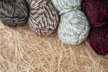 Vintage Knitting needles and yarn on wooden background. natural wool knitting background. knitting yarn for handmade winter clothes. Close Up of yarn balls. Rainbow colors. Place for text, banner.